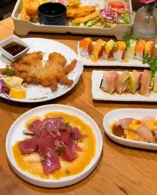 A bento box, chicken katsu, sashimi, and roll spread at Love Boat Sushi.