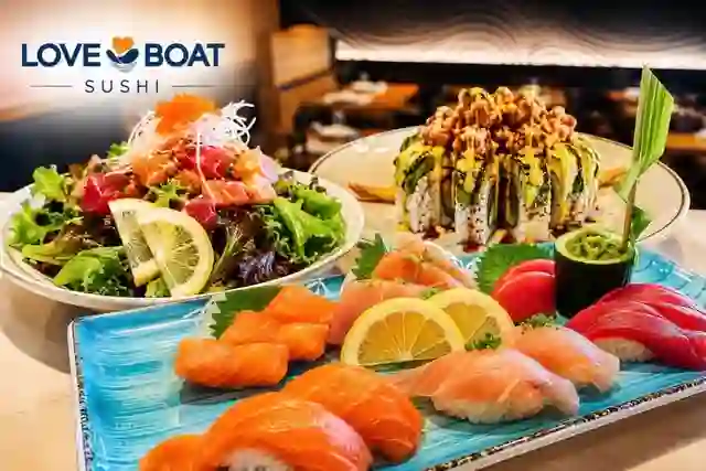 A salad, roll, and sashimi platter spread at Love Boat Sushi, San Marcos.